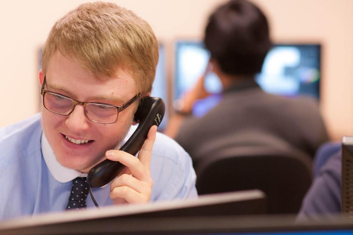 Man smiling and speaking on the phone